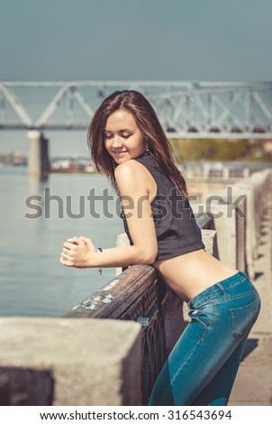 Outdoor summer smiling lifestyle portrait of pretty beautiful brunette young woman having fun in the city.