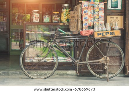 BANGKOK, THAILAND - July 1, 2017: Vintage style of Pepsi bottles stacked in plastic container on retro bike with retro shop background in Traditional Baan Bangkhen Museum in Bangkok Thailand.