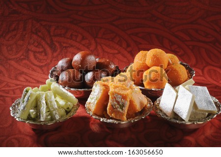 Close-up of bowls of traditional Indian sweets - stock photo