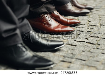 Men's legs in shoes on the street