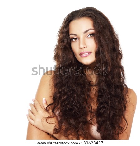 Beauty of young fresh woman with long brown healthy curly hair. Isolated on white background