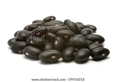 A small handful of black beans - preto. Beans isolated on a white background. Close-up.