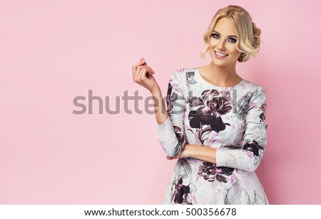 Beautiful Young Girl Solo - Fashion photo of a beautiful young woman in a pretty dress with flowers  posing over pink