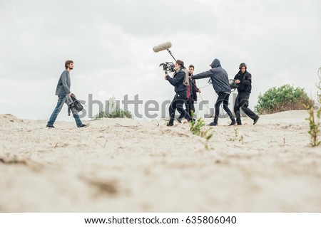 Behind the scene. Film crew team filming movie scene on outdoor location. Group cinema set