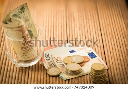 Euro And Turkish Lira Banknote And Coins On Brown Wooden Plank Use As Business Euro And Turkish Lira Banknote And Coins On Brown Wooden Plank Use As Business