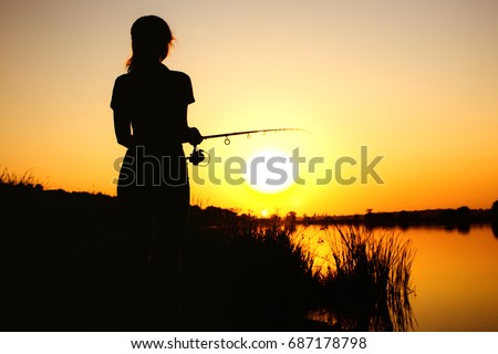 https://thumb1.shutterstock.com/display_pic_with_logo/1174673/687178798/stock-photo-silhouette-of-a-young-fishing-woman-on-the-river-bank-in-the-reeds-resting-on-the-nature-at-dawn-687178798.jpg