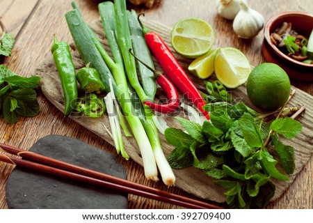 Vietnamese food ingredient board - ginger, chili, lime, spring onion, garlic, shallots, shiitake mushroom, mint, cilantro, coriander. All colorful spices make traditional asian food more delicious.
