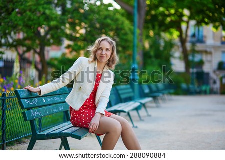https://thumb1.shutterstock.com/display_pic_with_logo/118180/288090884/stock-photo-beautiful-young-woman-in-red-polka-dot-dress-sitting-on-bench-in-marais-paris-france-288090884.jpg