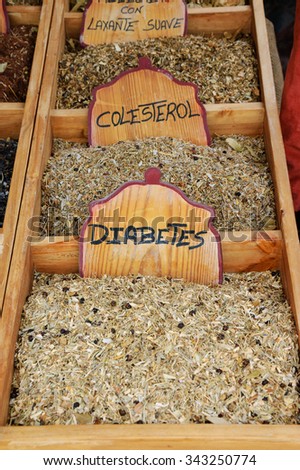 Variety of healing herbal teas at counter in street market in Portugal.