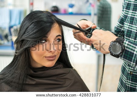 Young beautiful woman having her hair cut at the hairdresser's.