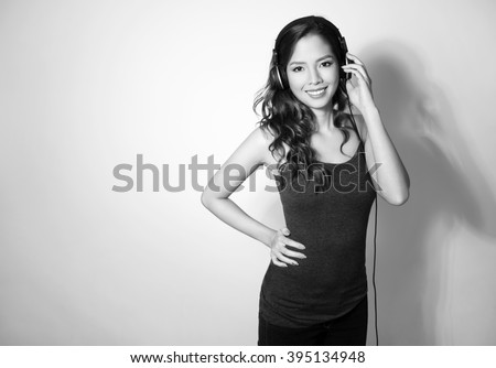 https://thumb1.shutterstock.com/display_pic_with_logo/122137/395134948/stock-photo-beautiful-young-asian-woman-listening-to-music-with-headphones-395134948.jpg