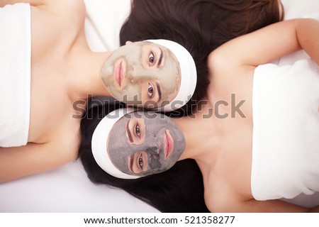 Use of a face mask to the face two young women in a beauty salon