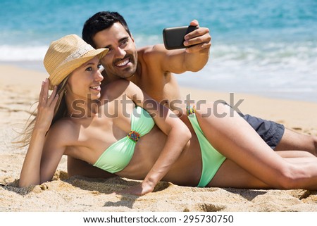 https://thumb1.shutterstock.com/display_pic_with_logo/124564/295730750/stock-photo-happy-couple-relaxing-on-beach-taking-selfie-picture-with-camera-smartphone-295730750.jpg