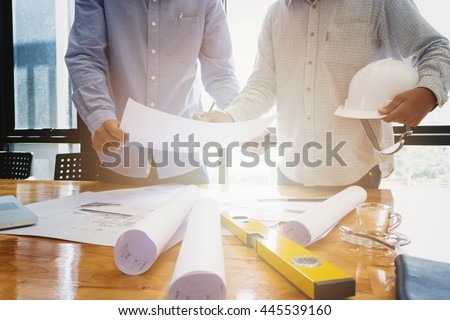 Architects concept, Architects working with blueprints in the office