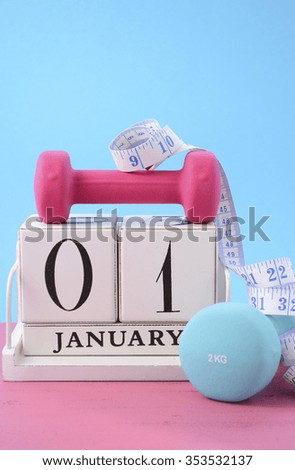 Happy New Year Fitness Resolution with pink and blur dumbbells and tape measure with white block calendar for January 1st.