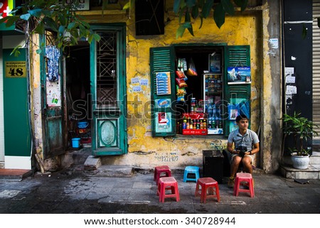 HANOI, VIETNAM - NOVEMBER 18, 2015: Unidentified street vendors in Hanoi ancient town, Vietnam.