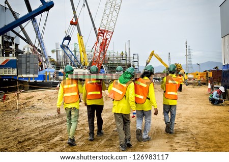 Construction workers are bearing wood, to be unity