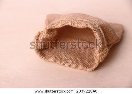 stock-photo-empty-jute-sack-on-wood-back