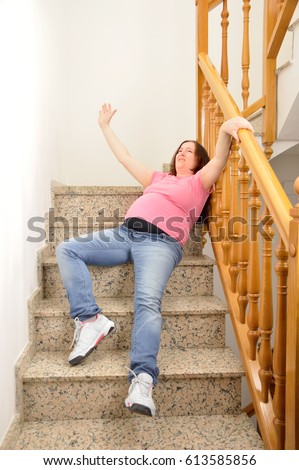 stock-photo-pregnant-woman-falling-down-on-stairs-with-hands-up-to-try-to-catching-the-railing-613585856.jpg