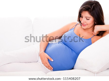 Pregnant woman relaxing at home on the couch