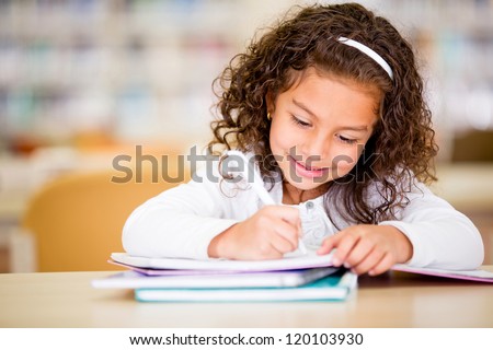 Girl studying at school looking very happy