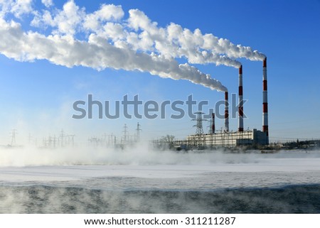 winter landscape smoke from the chimneys Zainsk TPP against the blue sky frosty misty morning