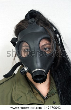 stock-photo-a-young-woman-wearing-a-gas-mask-and-a-military-olive-drab-jacket-149470043.jpg