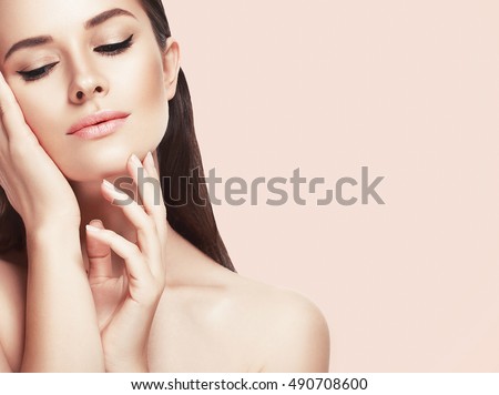 Beautiful woman face close up studio on pink