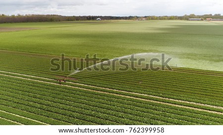 Aerial bird view photo of industrial irrigation sprinkler used to irrigate agricultural crops sprinkler irrigation is method of applying irrigation water which is similar to natural rainfall