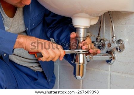 a plumber at work in a bathroom