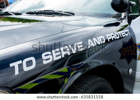 stock-photo-surrey-uk-st-may-close-up-of-american-police-car-with-the-slogan-to-serve-and-protect-635831558.jpg