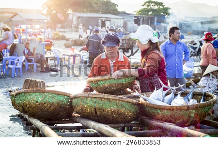 LONG HAI, VIET NAM - MAY 31 2015: People's daily life at fishing village Long Hai, they collecting fresh fishes from boat and open up a market in the early morning