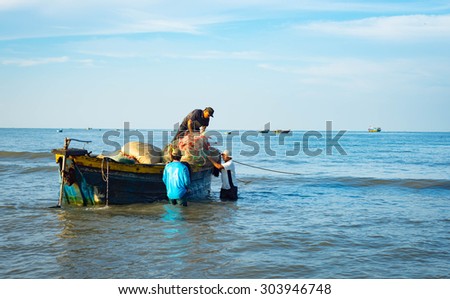 Long Hai, Ba Ria - Vung Tau, Vietnam - 31 May 2015: fishermen carrying net back home from a long trip at Long Hai, Ba Ria - Vung Tau, Vietnam