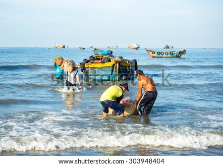 Long Hai, Ba Ria - Vung Tau, Vietnam - 31 May 2015: Fishermen carrying net back home from a long trip at Long Hai, Ba Ria - Vung Tau, Vietnam