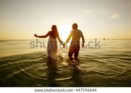 https://thumb1.shutterstock.com/display_pic_with_logo/134434/447596644/stock-photo-romantic-couple-on-the-beach-at-colorful-sunset-on-background-447596644.jpg