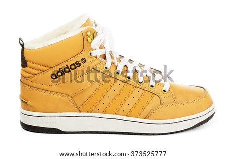 SAMARA, RUSSIA - January 4, 2016: Adidas Neo sneaker for the winter, in yellow, showing the Adidas logo and famous three stripes, illustrative editorial