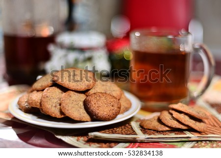 ginger biscuits with tea and jar of jam on a New Year's background