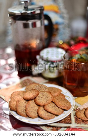 ginger biscuits with tea and jar of jam on a New Year's background