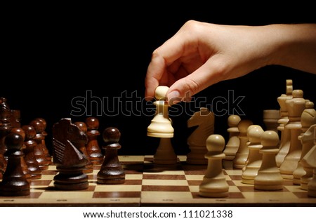 Chess board with chess pieces isolated on black