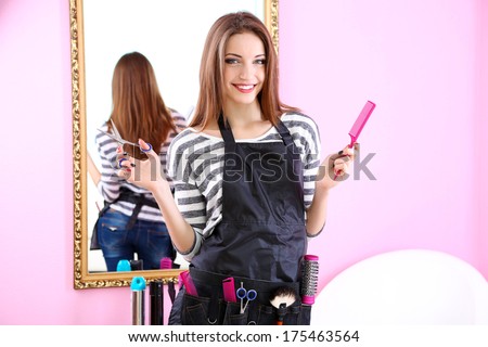 Beautiful girl hairdresser in beauty salon