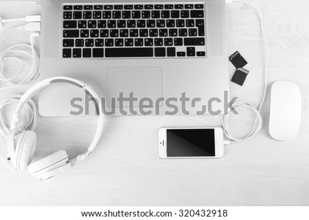 Computer peripherals and laptop accessories on white wooden background