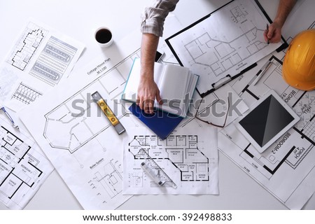Architect working with blueprints