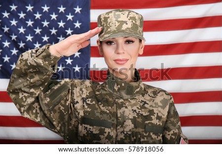 Saluting Female Soldier With USA Flag On Background Saluting Female Soldier With USA Flag On Background