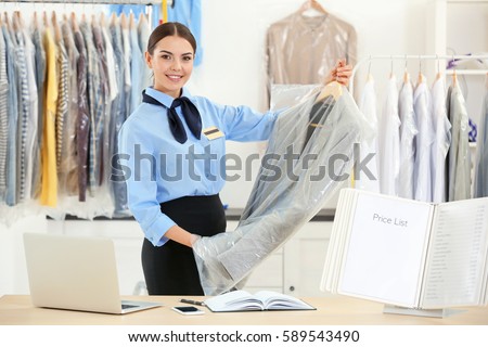 Female worker in dry-cleaning salon