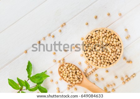 Top view image of soy been on spoon it on white table background with copy space,healthy concept.