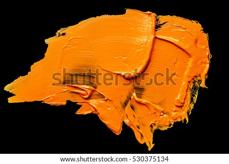orange oil paint spot isolated on a black