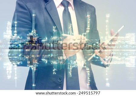 Double exposure of businessman with Petrochemical factory