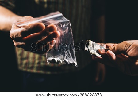 Drug addict buying narcotics and paying