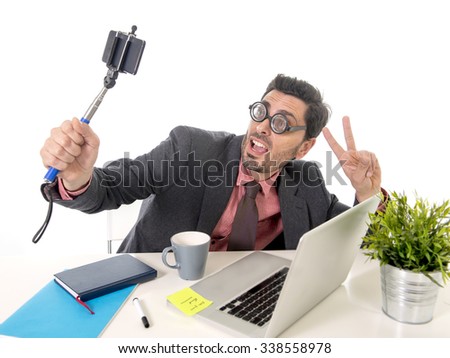 stock-photo-funny-nerd-businessman-with-thick-glasses-in-suit-and-tie-working-at-office-desk-taking-selfie-338558978.jpg