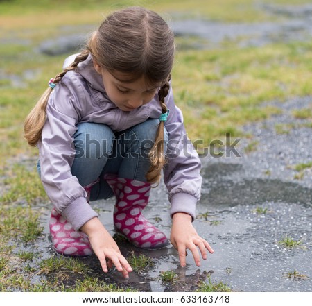 The child playing in a puddle